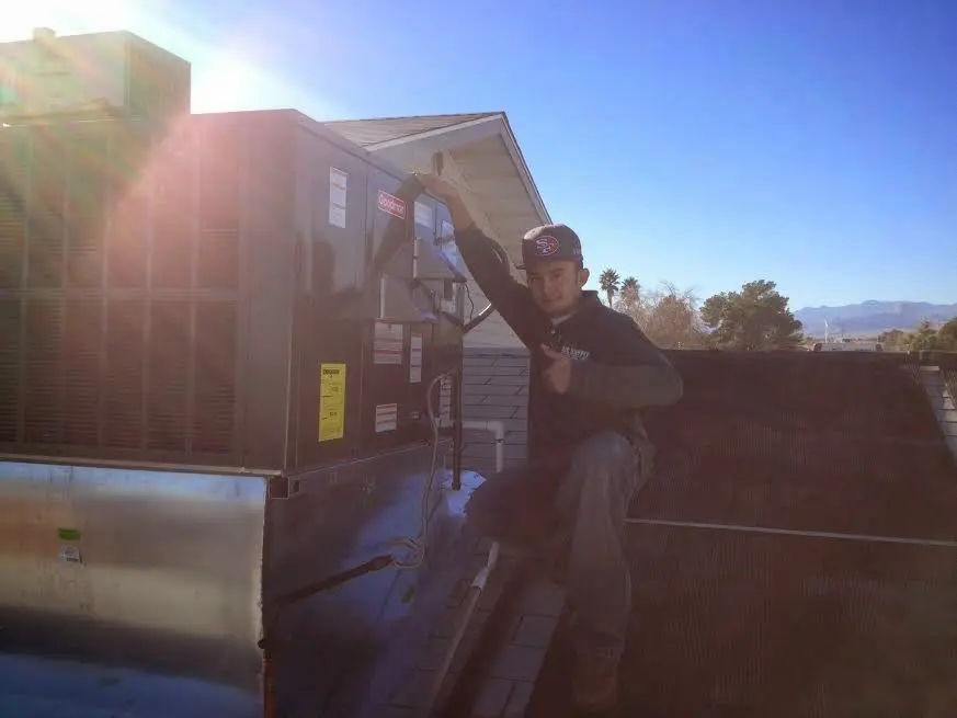 HVAC technician performing Boiler Repair on a rooftop unit in Chula Vista